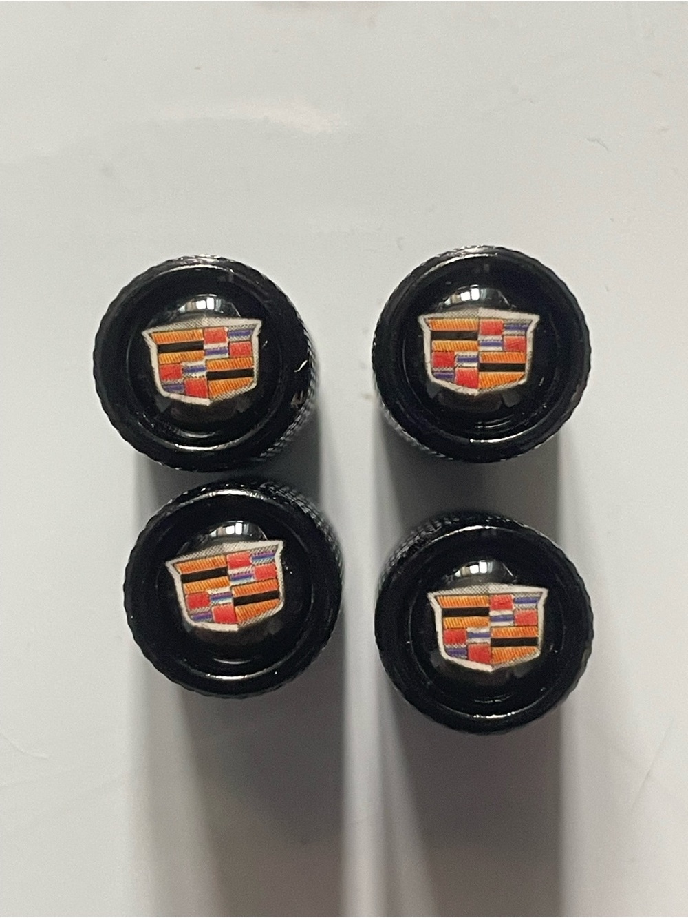 Cadillac Black Tire Valve Stem Caps with Crest Logo (Set of 4)